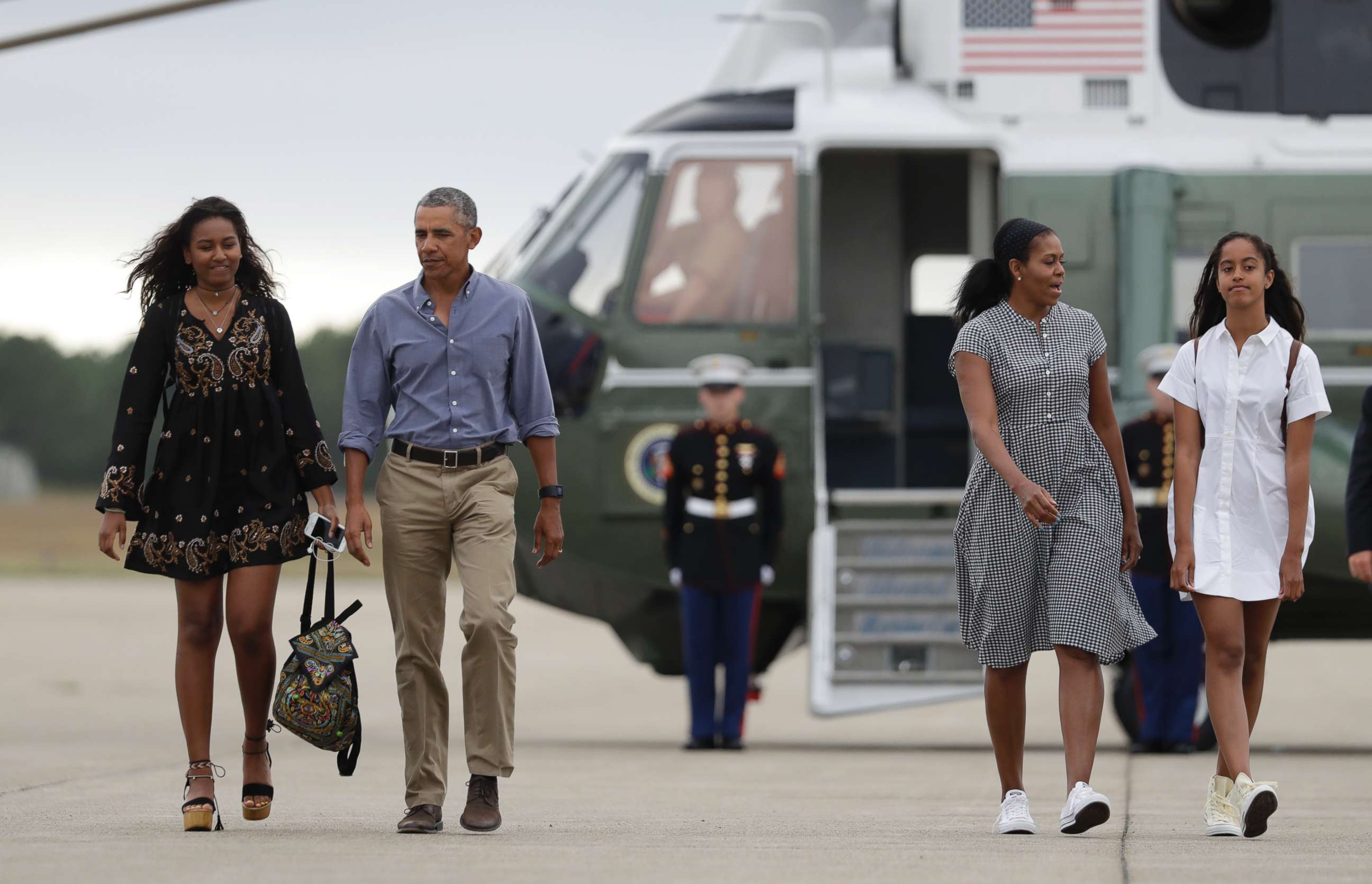 PHOTO: President Barack Obama with first lady Michelle Obama and their daughters Malia, right, and Sasha, left, walk on the tarmac to board Air Force One at Air Station Cape Cod in Mass., Sunday, Aug. 21, 2016.