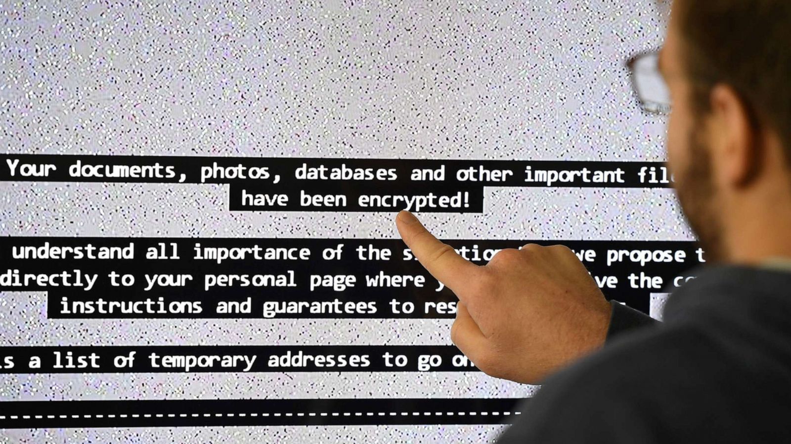 PHOTO: A man points at the large screen of a computer infected by a virus in Rennes, France, Nov. 3, 2016.