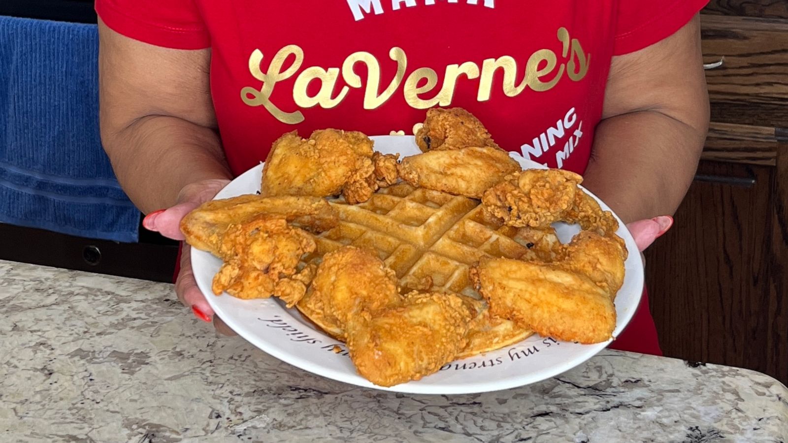 PHOTO: Laverne Richardson with a plate of chicken and waffles.