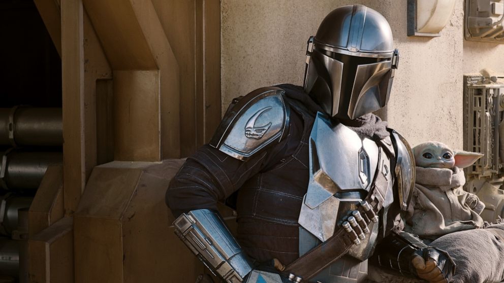 PHOTO: The Mandalorian (Pedro Pascal) and the Child in a scene from the movie "The Mandalorian" season two, exclusively on Disney+. 