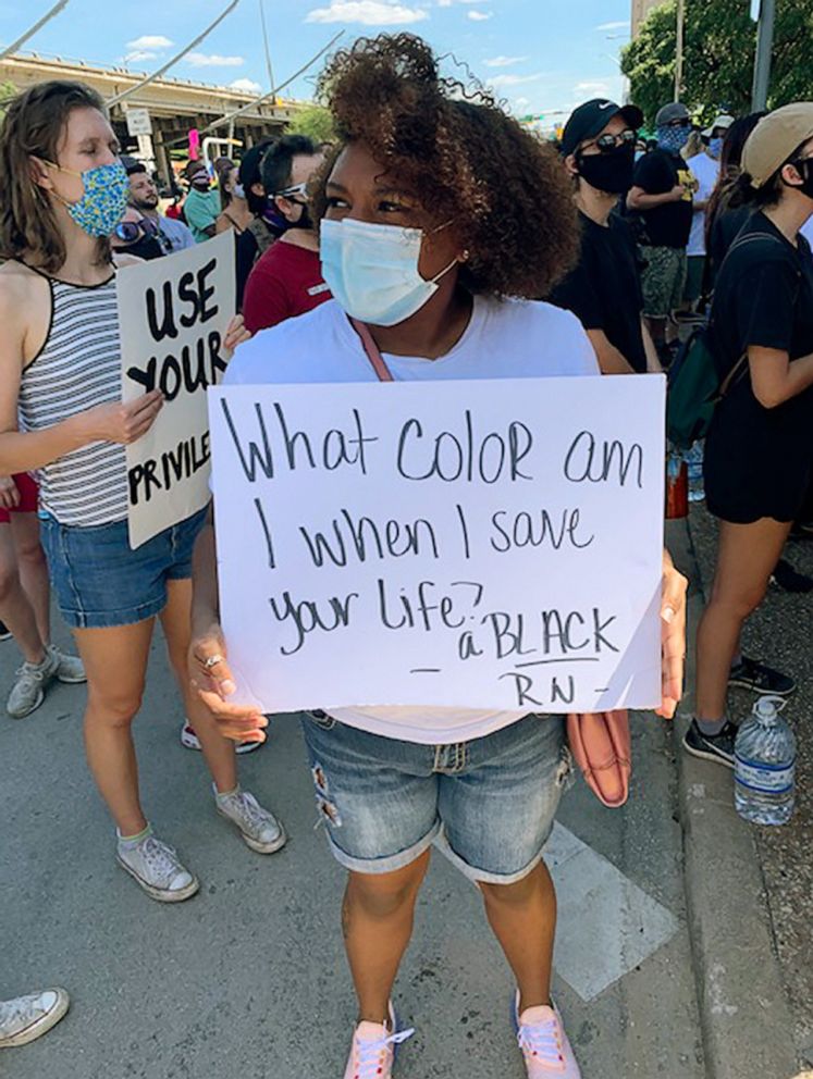 PHOTO: Anna Maria Ruiz joins a protest in Austin, Texas, May 31, 2020, condemning the death of George Floyd before heading in for work at North Austin Medical Center.