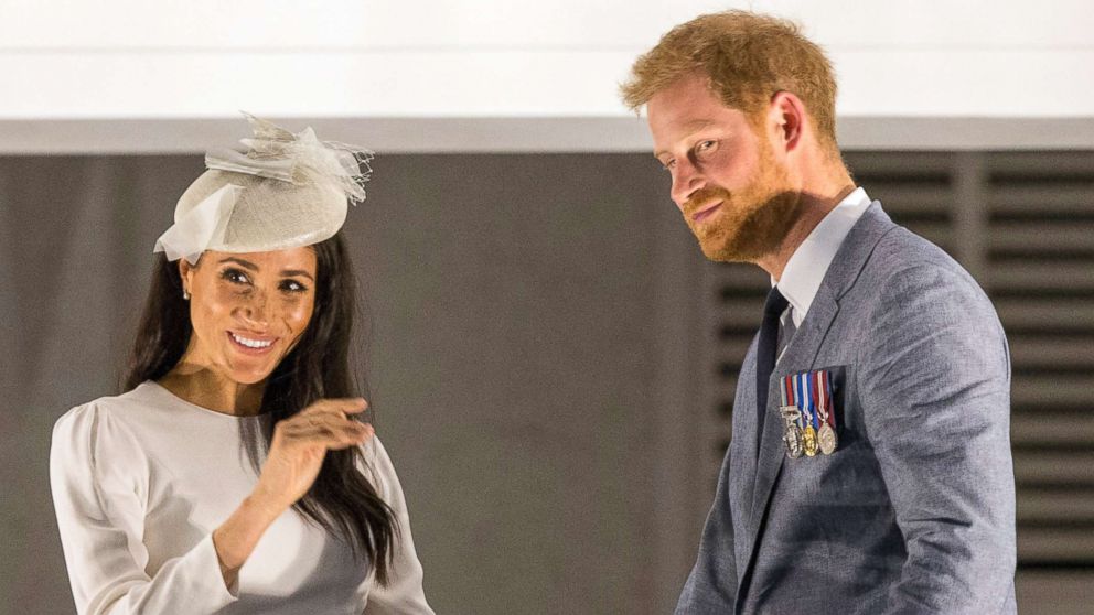 PHOTO: Prince Harry and Meghan Markle wave from the balcony of the Grand Pacific Hotel where they greeted the crowd who had turned out to welcome them in the rain, Oct. 23, 2018, in Suva, Fiji.