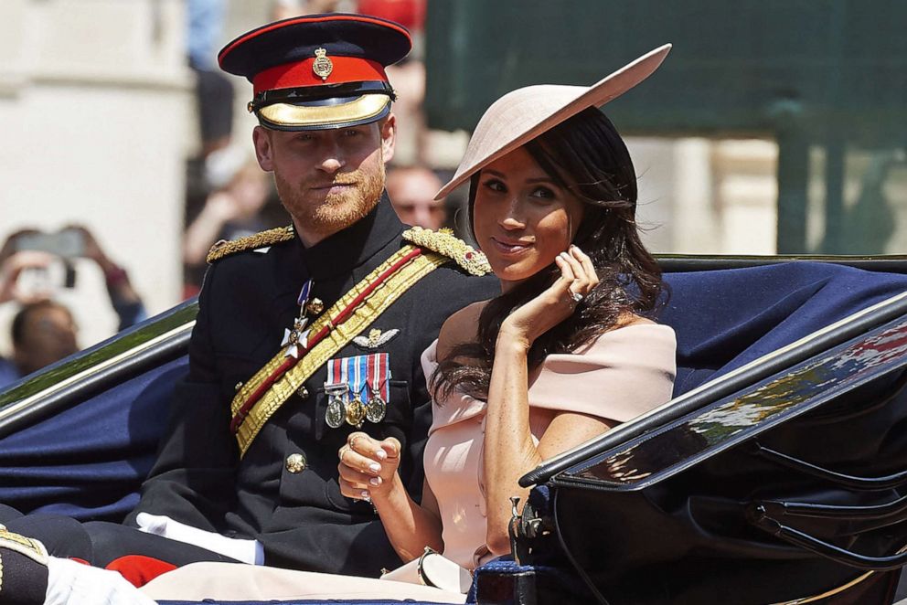 PHOTO: Britain's Prince Harry, Duke of Sussex and Britain's Meghan, Duchess of Sussex return in a horse-drawn carriage after attending the Queen's Birthday Parade, 'Trooping the Colour' on Horseguards parade in London on June 9, 2018.