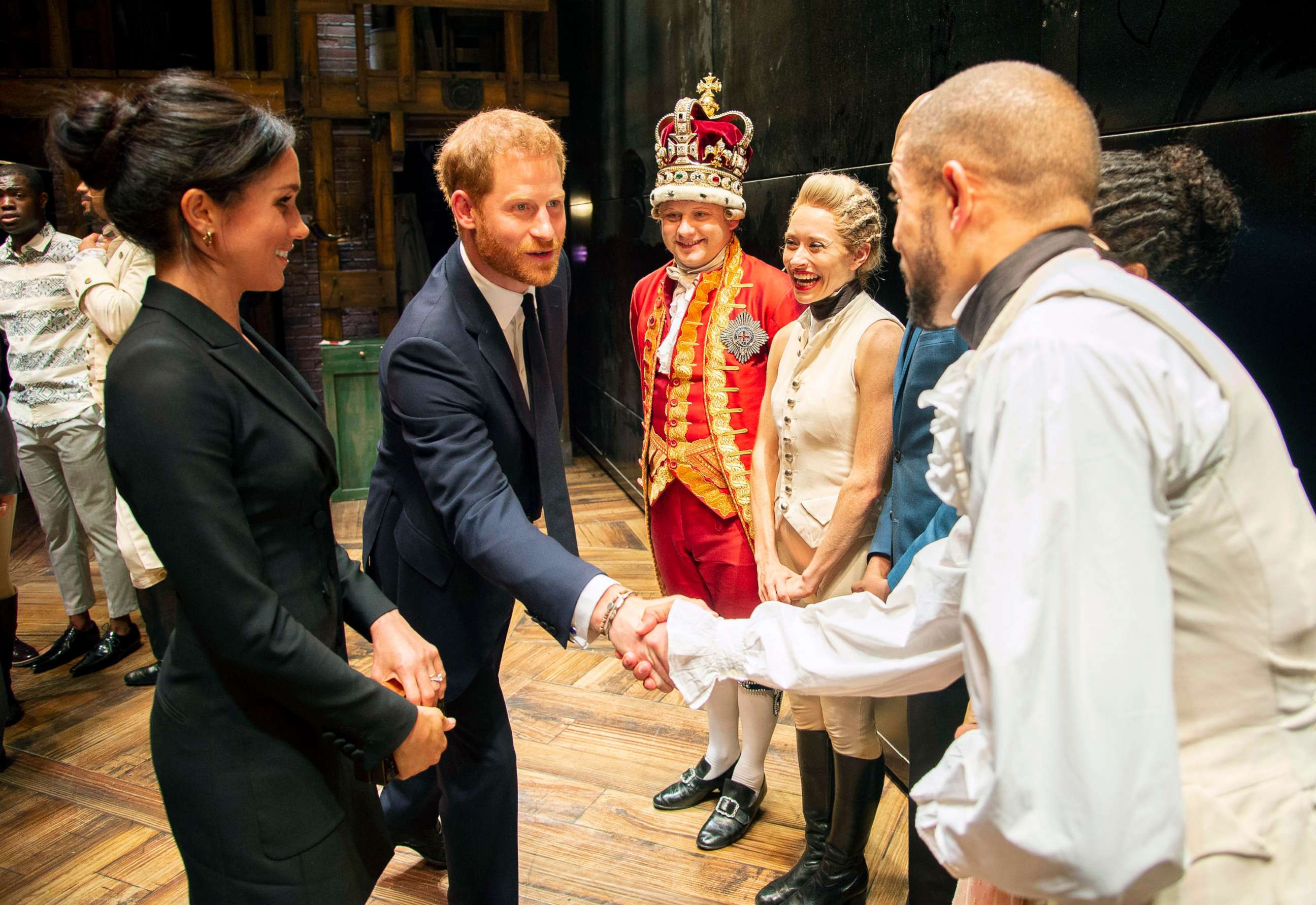 PHOTO: Prince Harry and Duchess Meghan Markle of Sussex after the performance meeting cast and crew backstage at the Victoria Palace Theatre, London, Aug. 30, 2018.