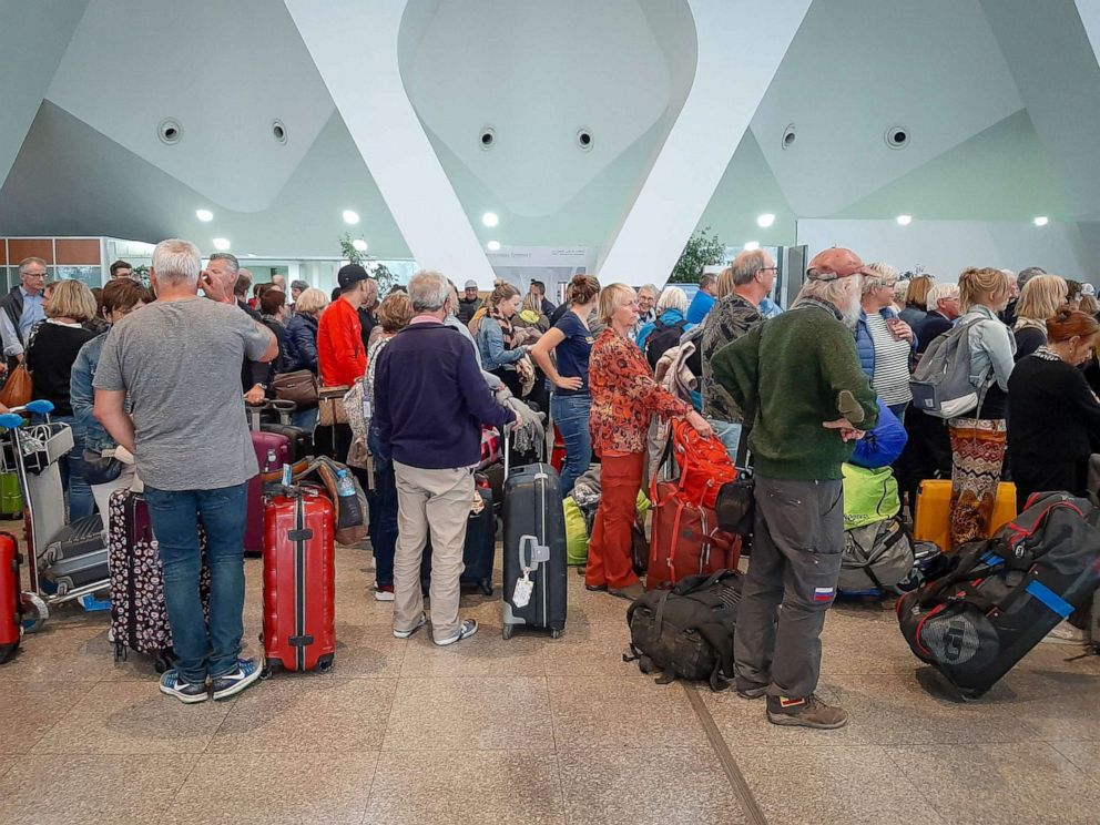 PHOTO: Passengers wait for their flights at the Marrakesh Airport on March 15, 2020. - Several sPassengers wait for their flights at the Marrakesh Airport, March 15, 2020.