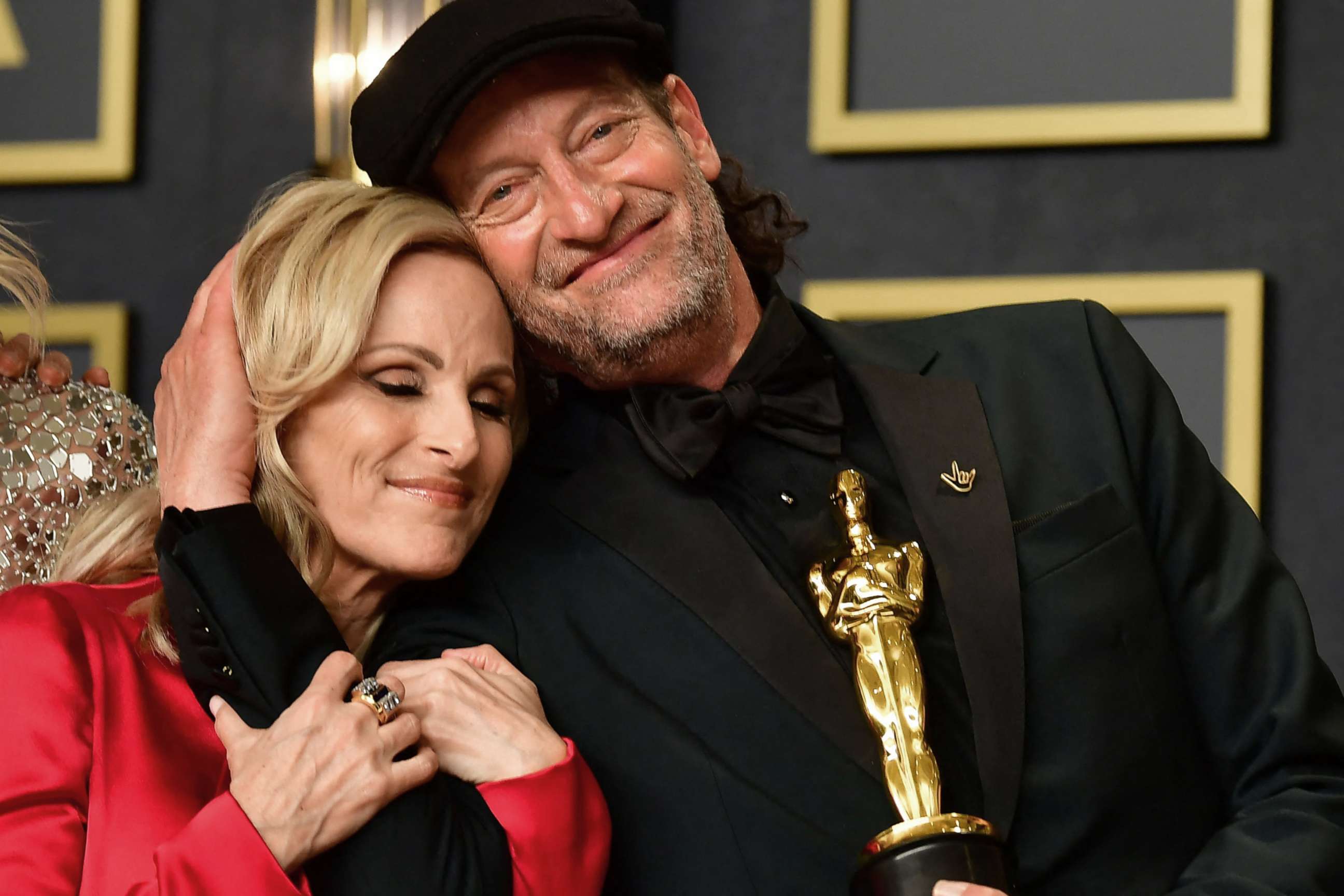 PHOTO: Actress Marlee Matlin and actor Troy Kotsur embrace as the cast of CODA, winner of Best Picture, gathers in the press room during the 94th Oscars at the Dolby Theatre in Hollywood, Calif., March 27, 2022.