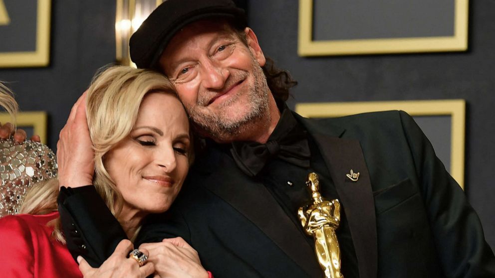 PHOTO: Actress Marlee Matlin and actor Troy Kotsur embrace as the cast of CODA, winner of Best Picture, gathers in the press room during the 94th Oscars at the Dolby Theatre in Hollywood, Calif., March 27, 2022.