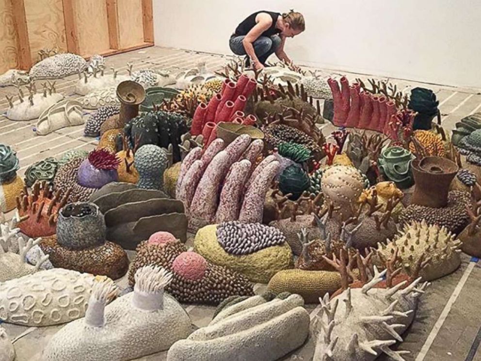 PHOTO: Sculptor Courtney Mattison installs an exhibition of her work.