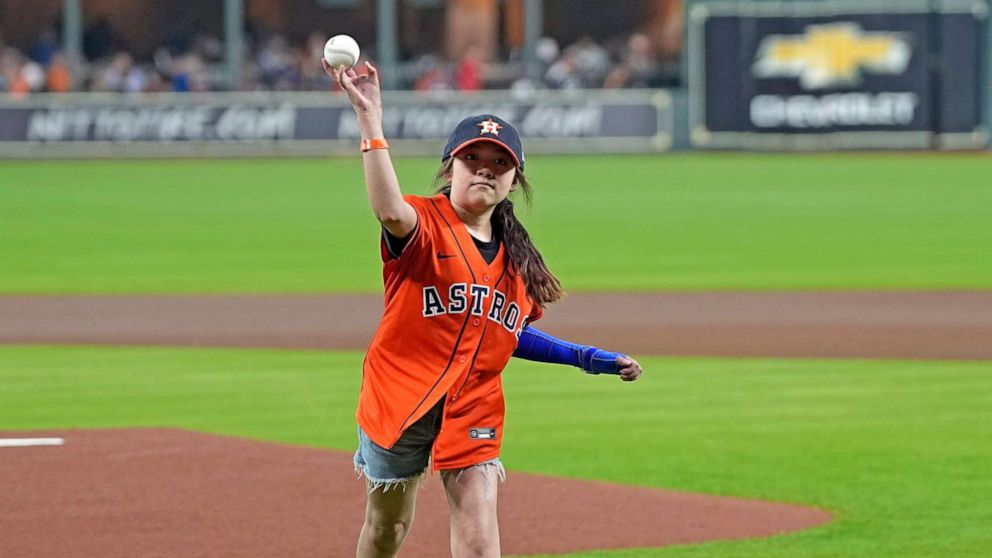 PHOTO: Mayah Zamora, a survivor of the school shooting at Robb Elementary in Uvalde, Texas, throws out a ceremonial first pitch before a baseball game between the Minnesota Twins and Houston Astros, Aug. 23, 2022, in Houston.