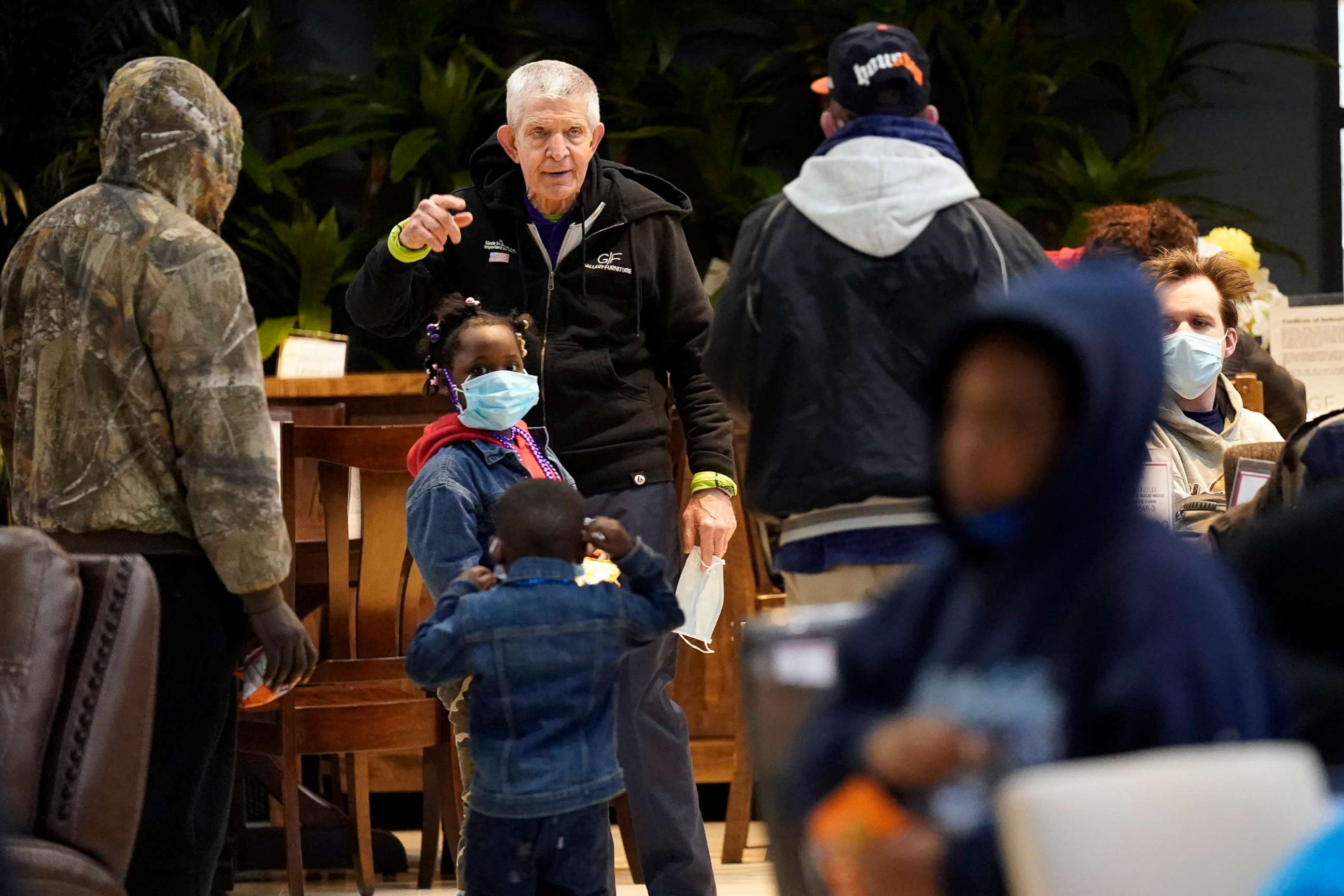 PHOTO: Owner Jim McIngvale, center, talks with people taking shelter inside his Gallery Furniture store after a cripping winter storm, Feb. 17, 2021, in Houston.