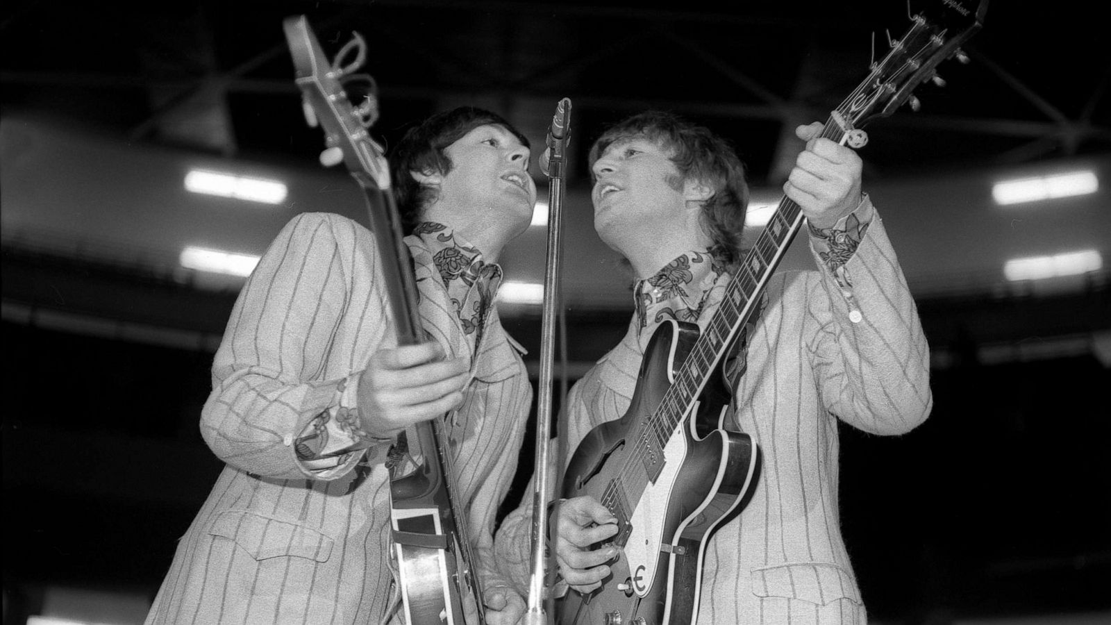 PHOTO: English Rock and Pop musicians Paul McCartney, left, on bass, and John Lennon, on guitar, perform with the Beatles in Detroit, Aug. 13, 1966.