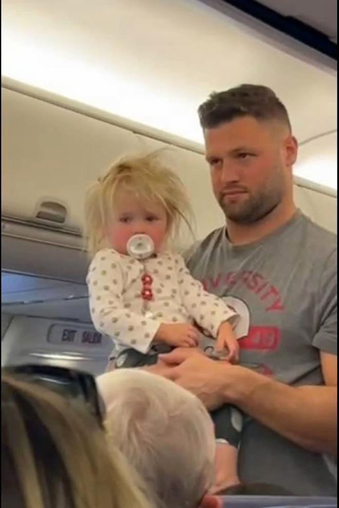 PHOTO: Vince Biegel holds his daughter Meadow on a flight from Kansas to Florida in October 2023.