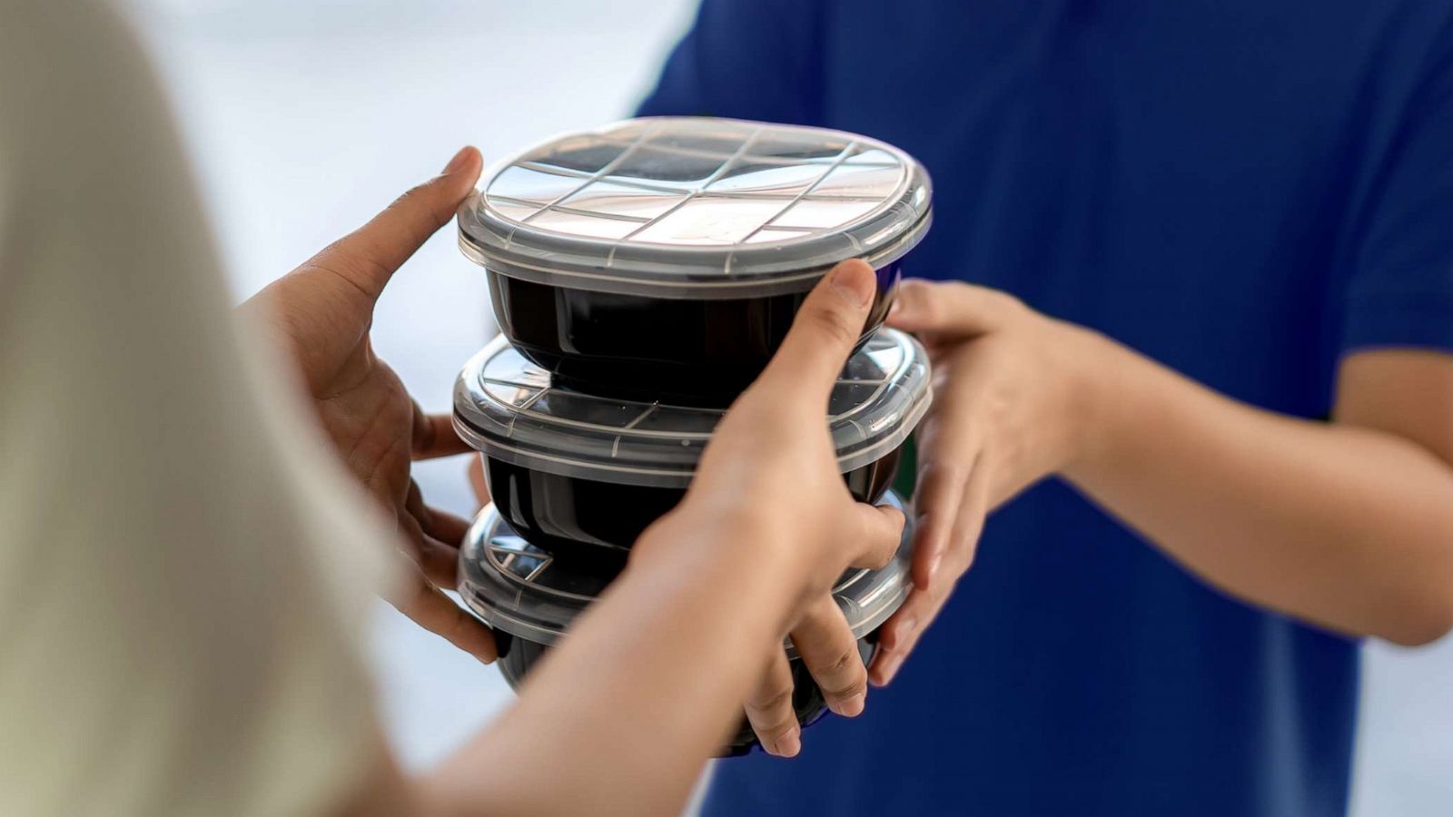 PHOTO: An undated stock photo depicts a man delivering food to a person at home.