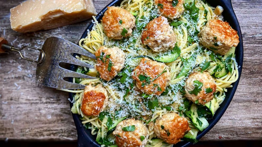 PHOTO: Garlic pasta with meatballs, zucchini strips and parmesan cheese.