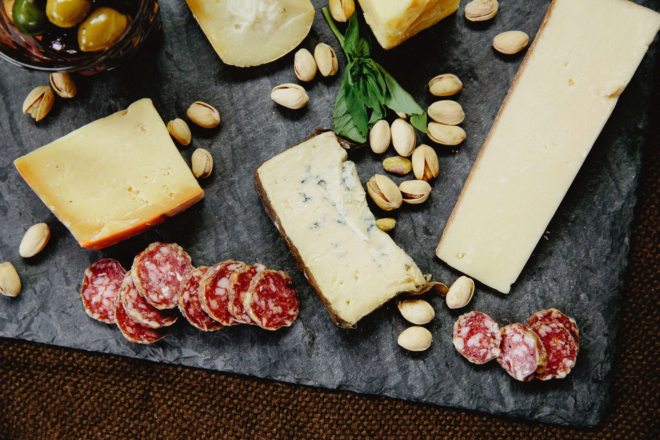 PHOTO: Meat, cheese and nuts on a slate board are seen in this stock photo.