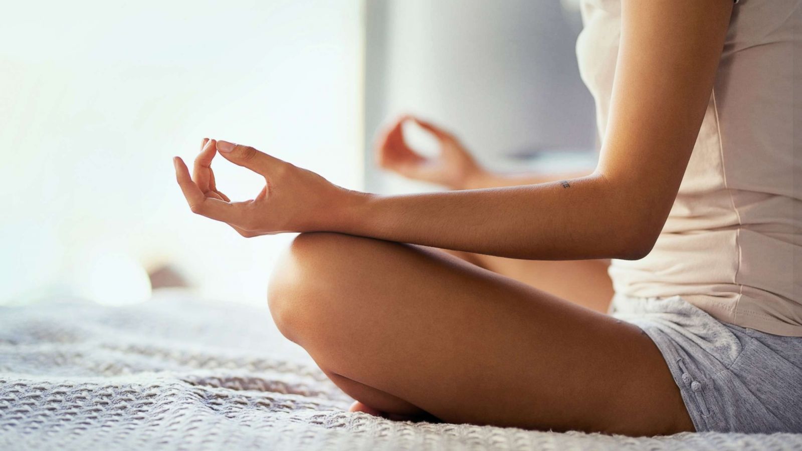 PHOTO: An undated stock photo depicts a young woman meditating at home.