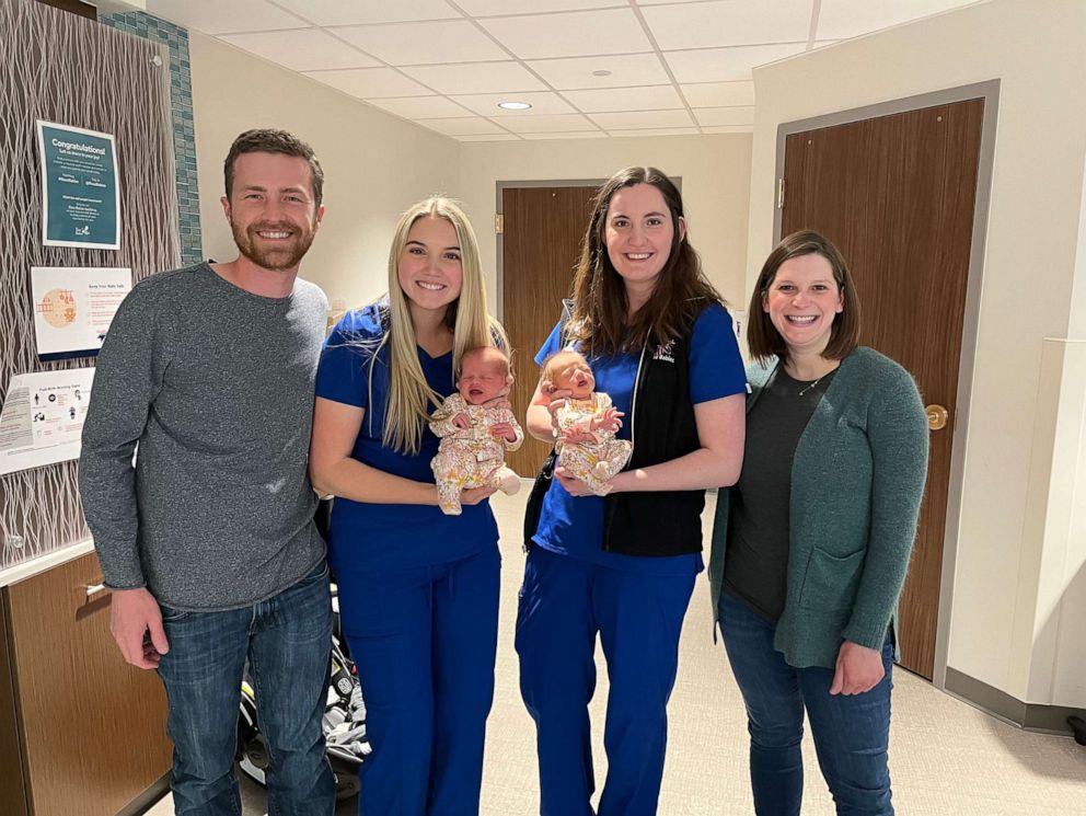 PHOTO: Chris and Lauren Meehan pose with nurses Emma Anderson and Julia Van Marter who are holding their twin daughters Emma and Julia.