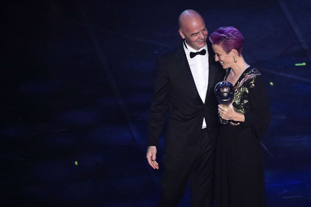 PHOTO: FIFA President Gianni Infantino (L) presents Megan Rapinoe with  the trophy for the Best FIFA Women's Player of 2019 Award during The Best FIFA Football Awards ceremony, on September 23, 2019, in Milan.