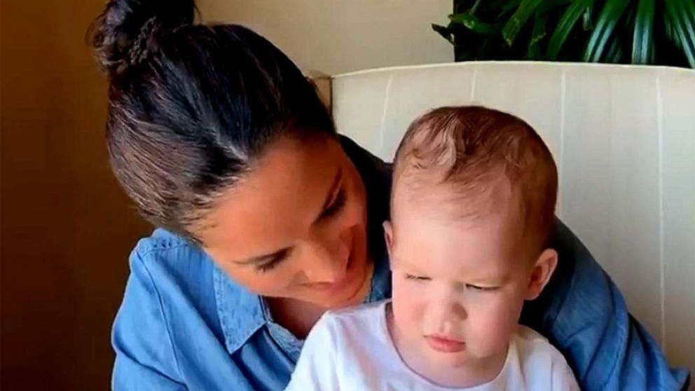 PHOTO: Meghan, Duchess of Sussex, reads a story to her son Archie in an image posted by âSave the Children UKâ on their Instagram account.