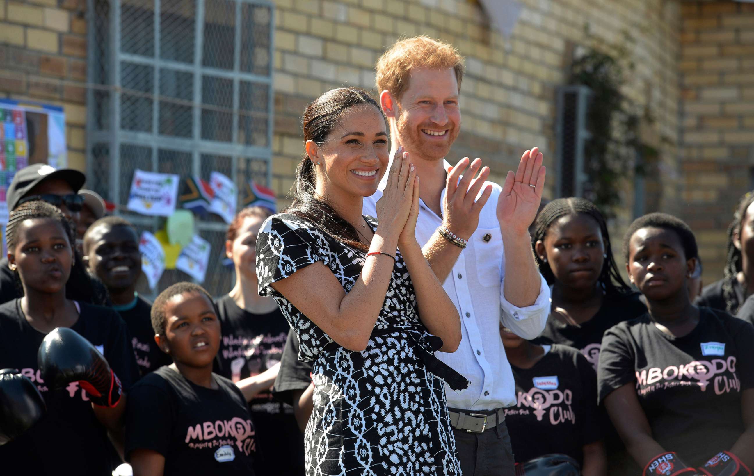 PHOTO: Britain's royal couple Prince Harry and Meghan, Duchess of Sussex, greet youths on a visit to the Nyanga Methodist Church in Cape Town, South Africa, Sept, 23, 2019.