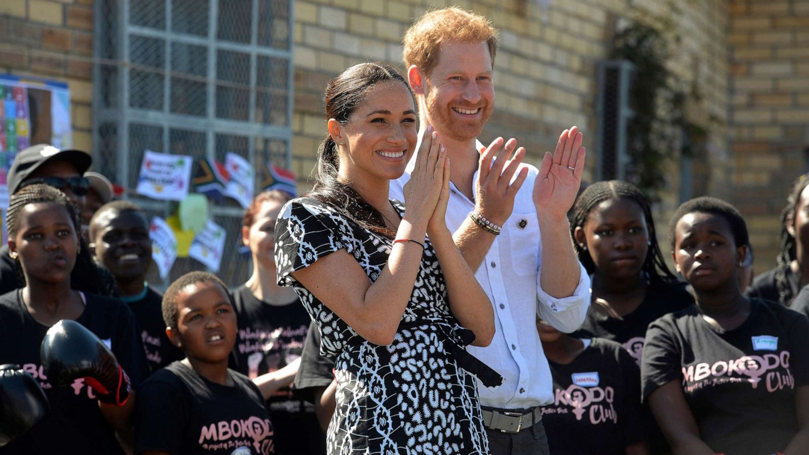 PHOTO: Britain's royal couple Prince Harry and Meghan, Duchess of Sussex, greet youths on a visit to the Nyanga Methodist Church in Cape Town, South Africa, Sept, 23, 2019.