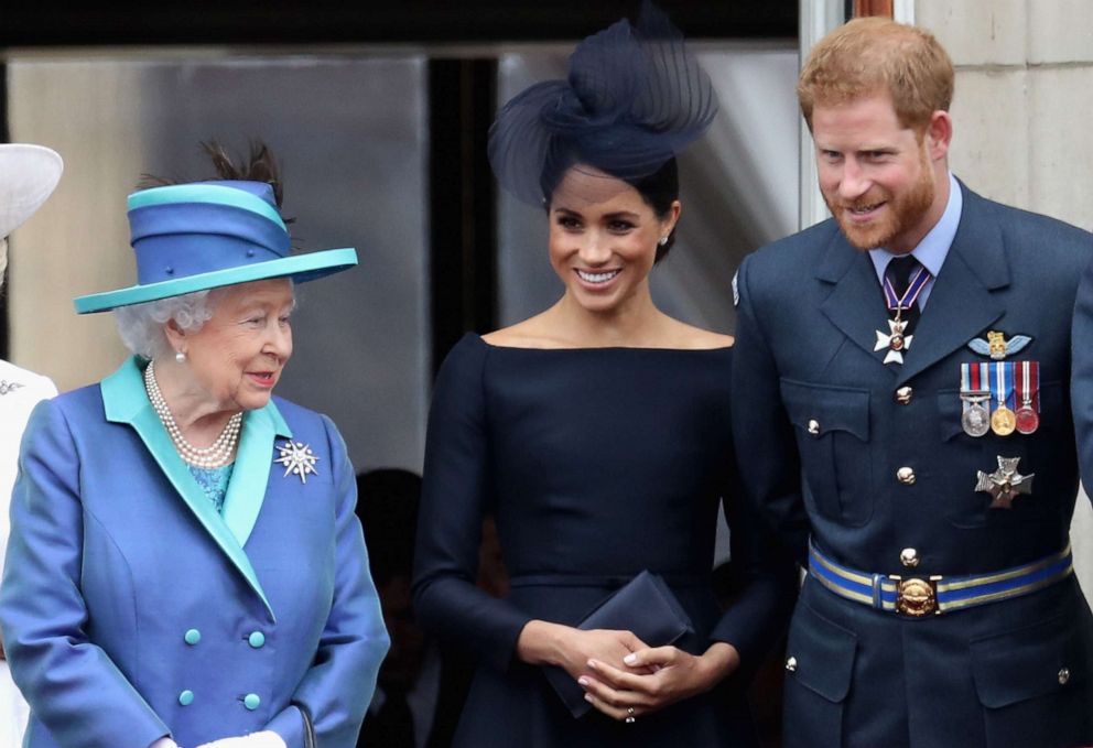 PHOTO: In this July 10, 2018, file photo, Queen Elizabeth II, Meghan, Duchess of Sussex, and Prince Harry, Duke of Sussex watch the RAF flypast on the balcony of Buckingham Palace in London.
