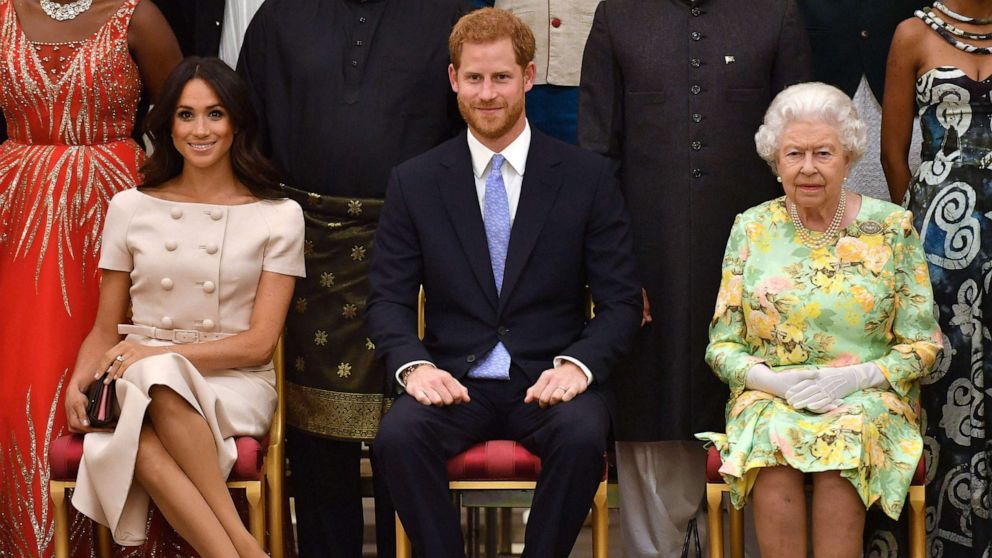 PHOTO: Meghan, Duchess of Sussex, Britain's Prince Harry, Duke of Sussex and Britain's Queen Elizabeth II pose for a picture during the Queen's Young Leaders Awards Ceremony at Buckingham Palace in London, June 26, 2018.