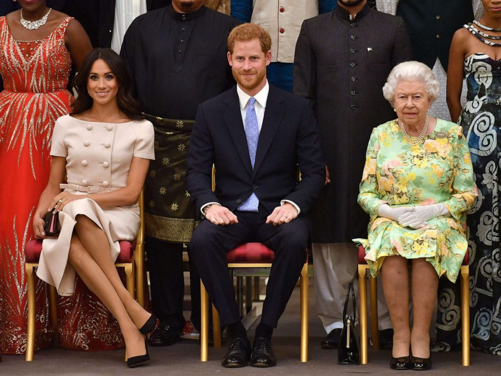 PHOTO: Meghan, Duchess of Sussex, Britain's Prince Harry, Duke of Sussex and Britain's Queen Elizabeth II pose for a picture during the Queen's Young Leaders Awards Ceremony at Buckingham Palace in London, June 26, 2018.