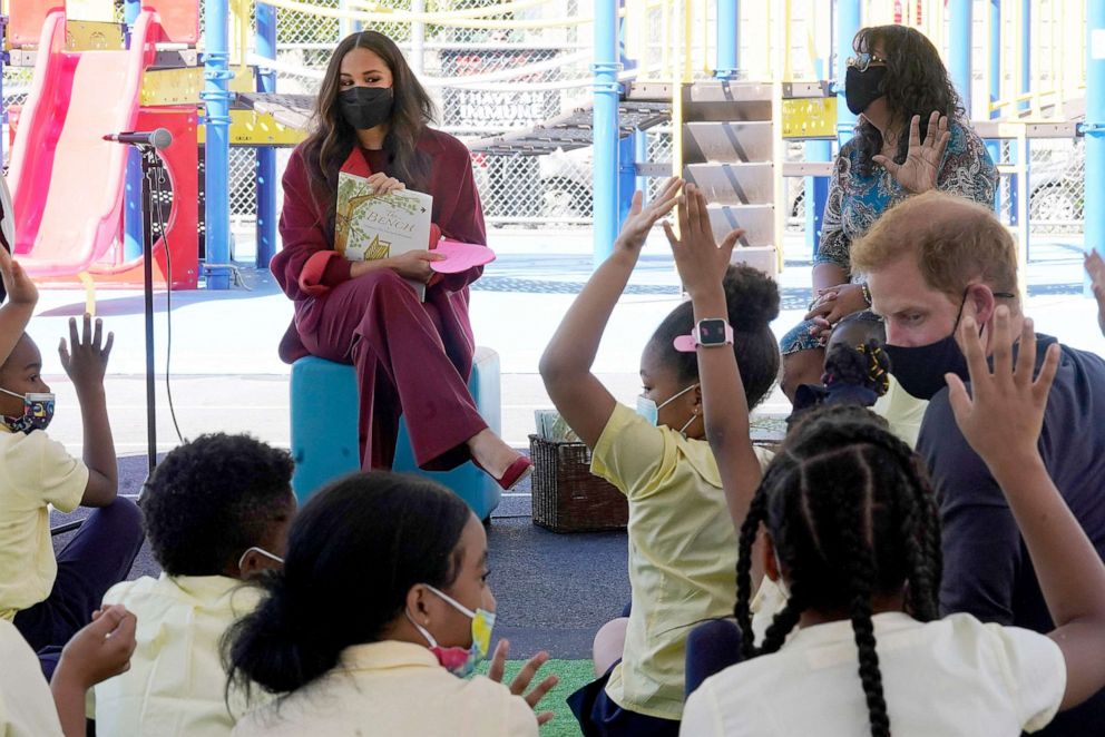 PHOTO: Meghan, the Duchess of Sussex reads from her book "The Bench," as Prince Harry, the Duke of Sussex listens along with second grade students during their visit to the Mahalia Jackson School, in New York's Harlem neighborhood, Sept. 24, 2021.