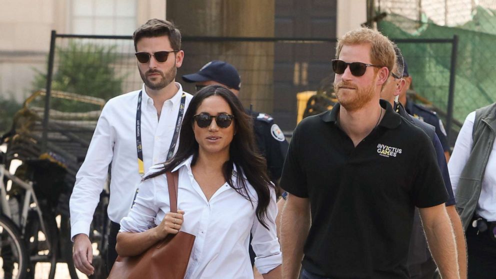 PHOTO: Prince Harry and Meghan Markle attend a tennis event with Jason Knauf, left, at the Invictus Games in Toronto, Sept. 25, 2017.