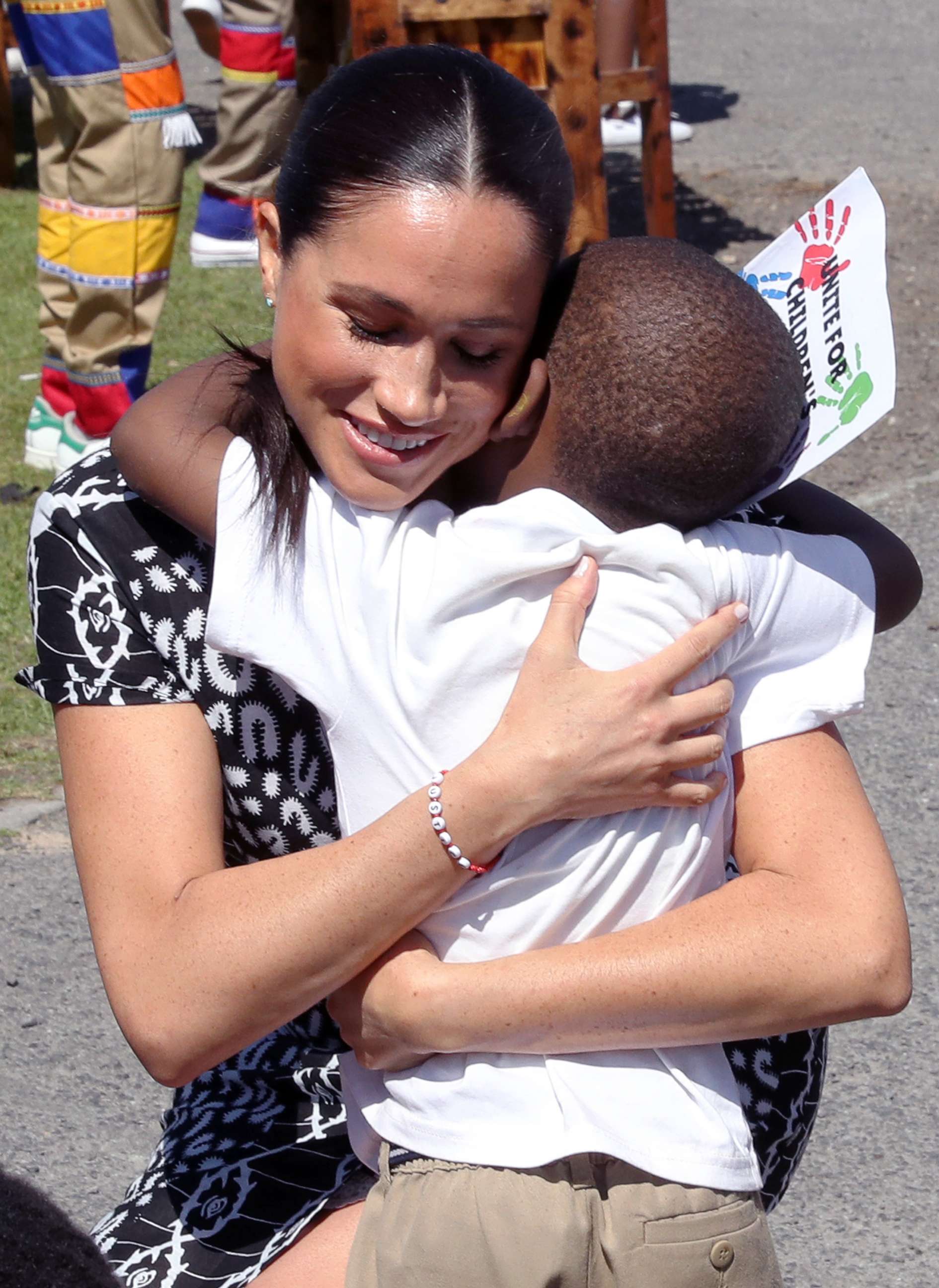 PHOTO: Meghan, Duchess of Sussex receives a hug from a young boy during a visit at a Justice Desk initiative in Nyanga township, with Prince Harry, Duke of Sussex, during their royal tour of South Africa, Sept. 23, 2019 in Cape Town, South Africa.
