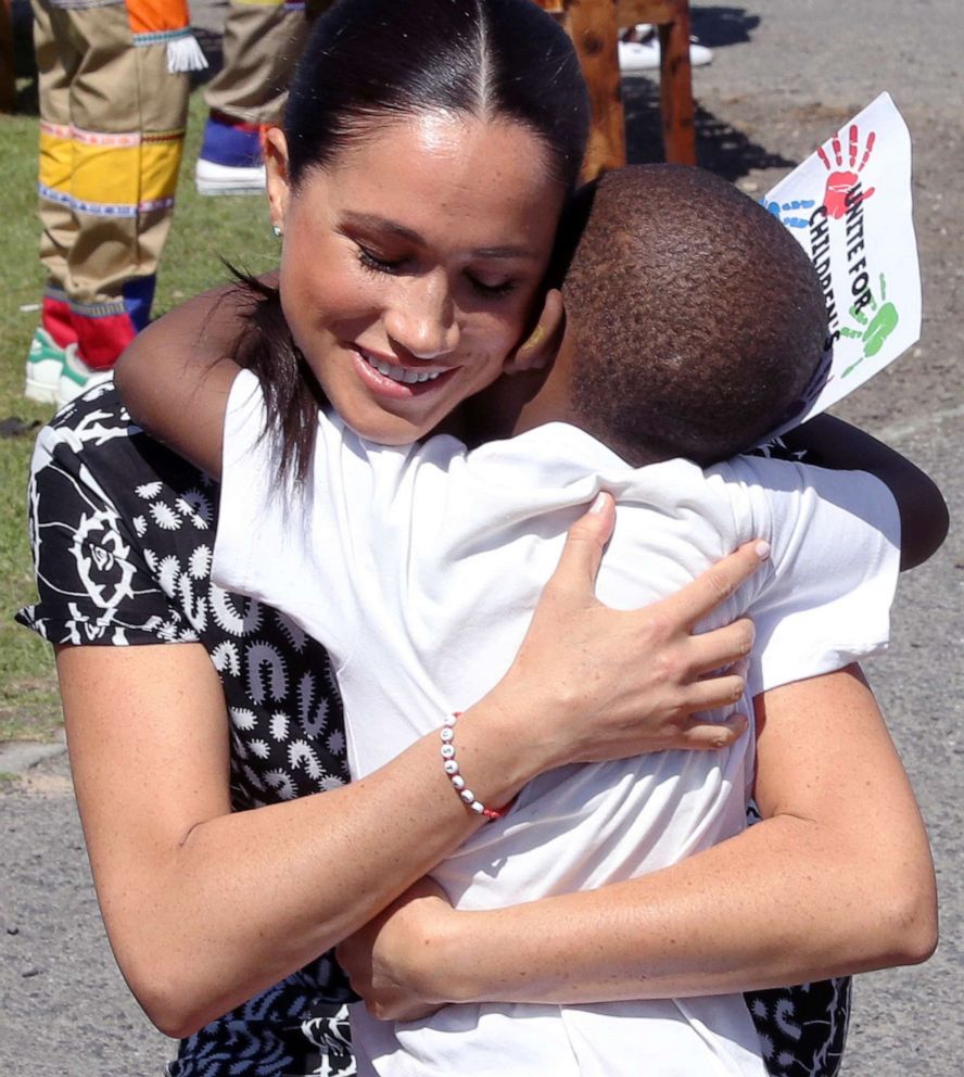 PHOTO: Meghan, Duchess of Sussex receives a hug from a young boy during a visit at a Justice Desk initiative in Nyanga township, with Prince Harry, Duke of Sussex, during their royal tour of South Africa, Sept. 23, 2019 in Cape Town, South Africa.