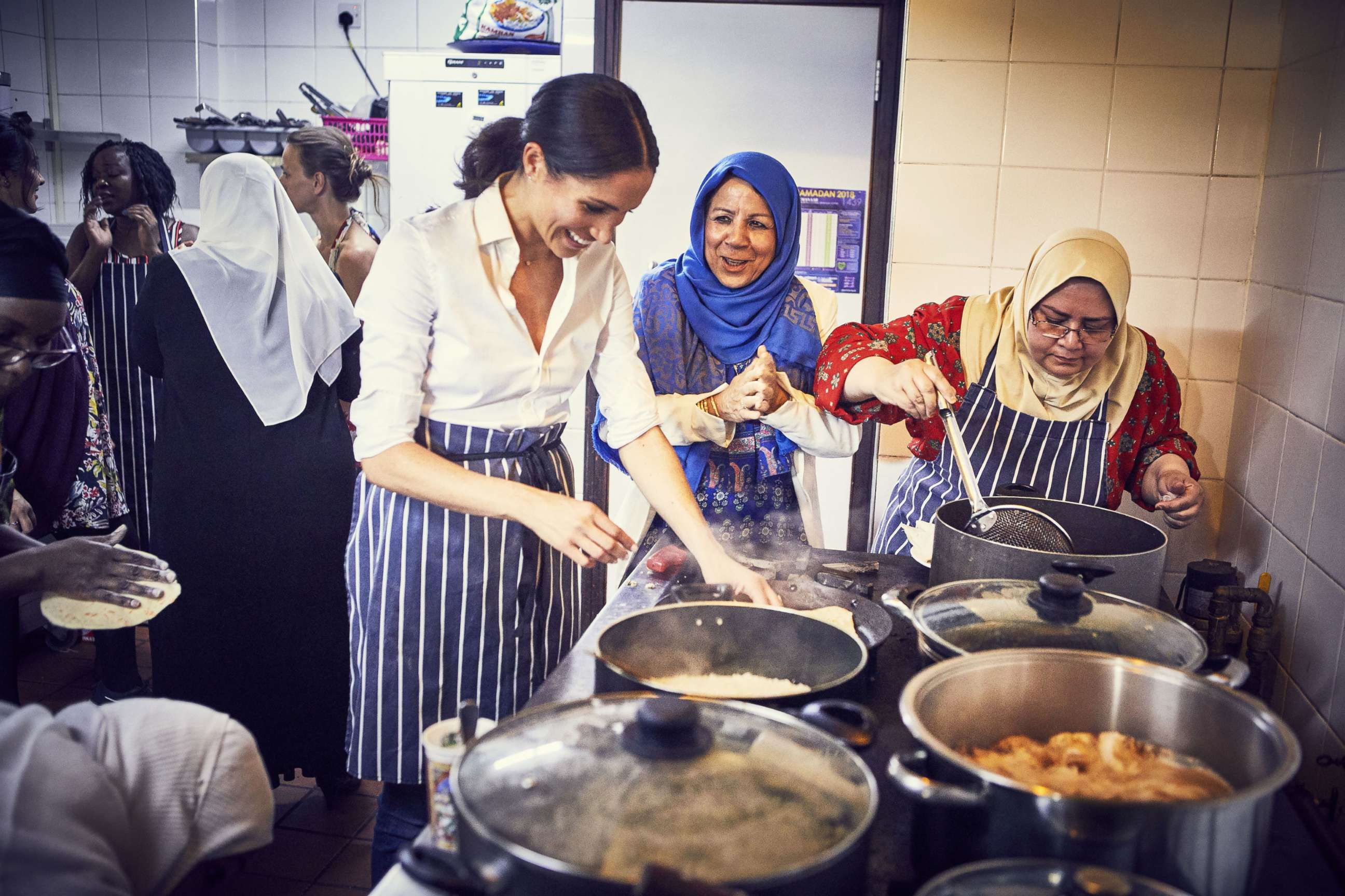 PHOTO: This undated handout image released by Kensington Palace on Sept. 17, 2018 shows, Meghan Markle, Duchess of Sussex cooking with women in the Hubb Community Kitchen at the Al Manaar Muslim Cultural Heritage Centre in West London.