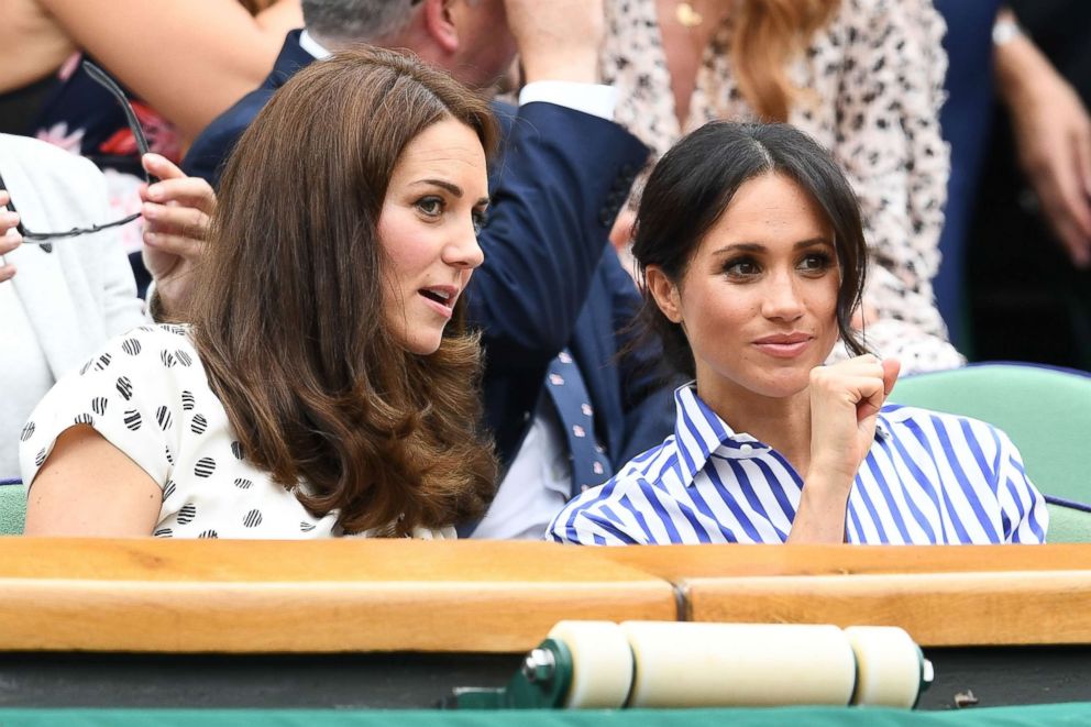 PHOTO: Catherine, Duchess of Cambridge and Meghan, Duchess of Sussex attend day twelve of the Wimbledon Lawn Tennis Championships at All England Lawn Tennis and Croquet Club on July 14, 2018 in London.
