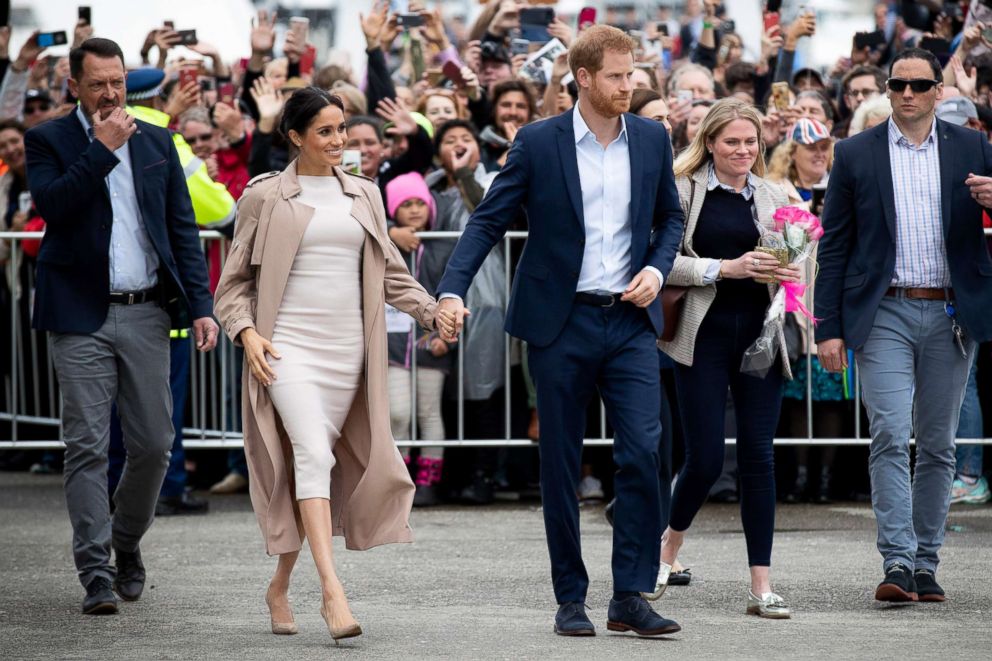 PHOTO: Britain's Prince Harry and his wife Meghan, Duchess of Sussex meet well-wishers during a public walk along the Viaduct Harbour in Auckland on Oct. 30, 2018.