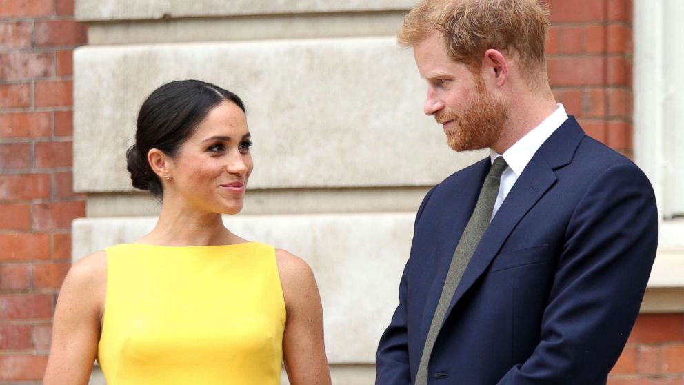 PHOTO: Meghan Markle, the Duchess of Sussex and Britain's Prince Harry, the Duke of Sussex stand as they attend the 'Your Commonwealth' Youth Challenge reception at Marlborough House in London, July 5, 2018.