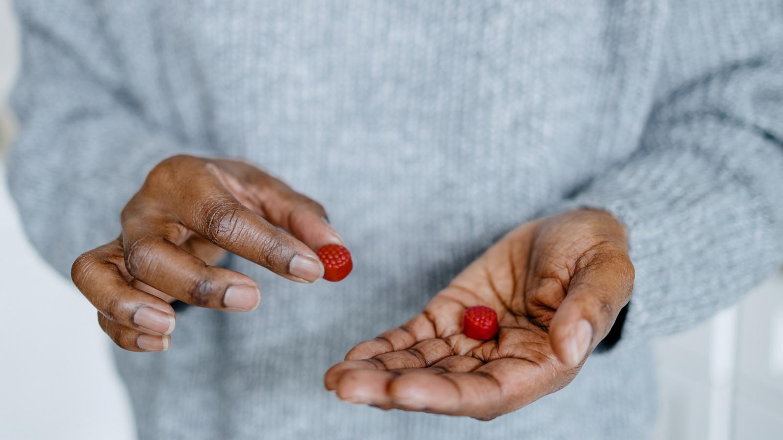 PHOTO: Woman Holds Fruit-Flavored Gummies