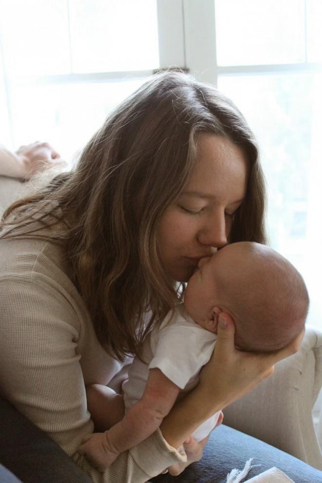 PHOTO: Sydney Melton gives her baby girl a kiss on her forehead.