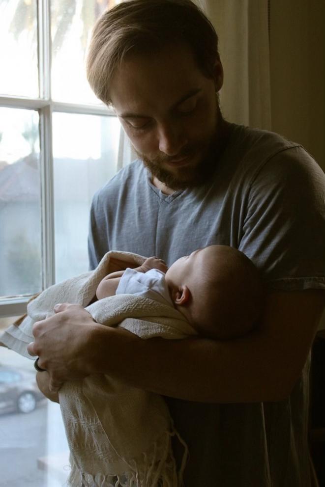 PHOTO: Trevor Melton holds his baby girl near a window.