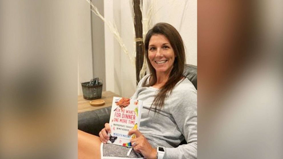 PHOTO: Meredith Masony, the founder of the popular parenting blog, poses with her new book, "Ask Me What's For Dinner One More Time: Inappropriate Thoughts on Motherhood." in an undated photo.