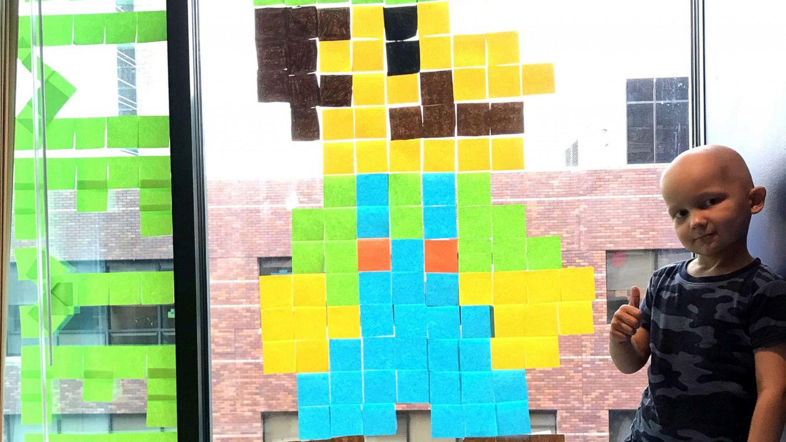 PHOTO: Meyer Mixdorf, 5, next to Post-it Note art of Luigi on the window of his hospital room at Children's Mercy Kansas City.