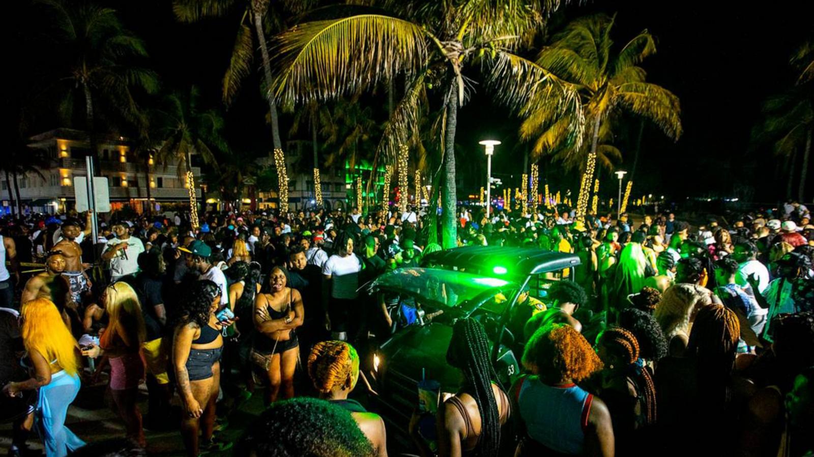 PHOTO: A Miami Beach Police vehicle cuts through crowds near Ocean Drive during Spring Break in Miami Beach, Florida, March 19, 2022.