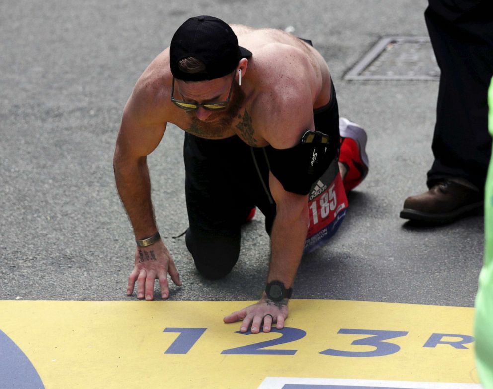 PHOTO: Micah Herndon, of Tallmadge, Ohio, crawls to the finish line in the 123rd Boston Marathon, April 15, 2019, in Boston.