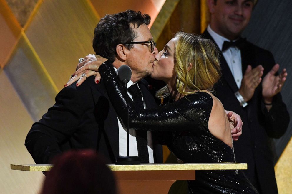 PHOTO: Actor Michael J. Fox kisses his wife Tracy Pollan as he accepts the Jean Hersholt Humanitarian Award during the Academy of Motion Picture Arts and Sciences' 13th Annual Governors Awards, Nov. 19, 2022, in Los Angeles.
