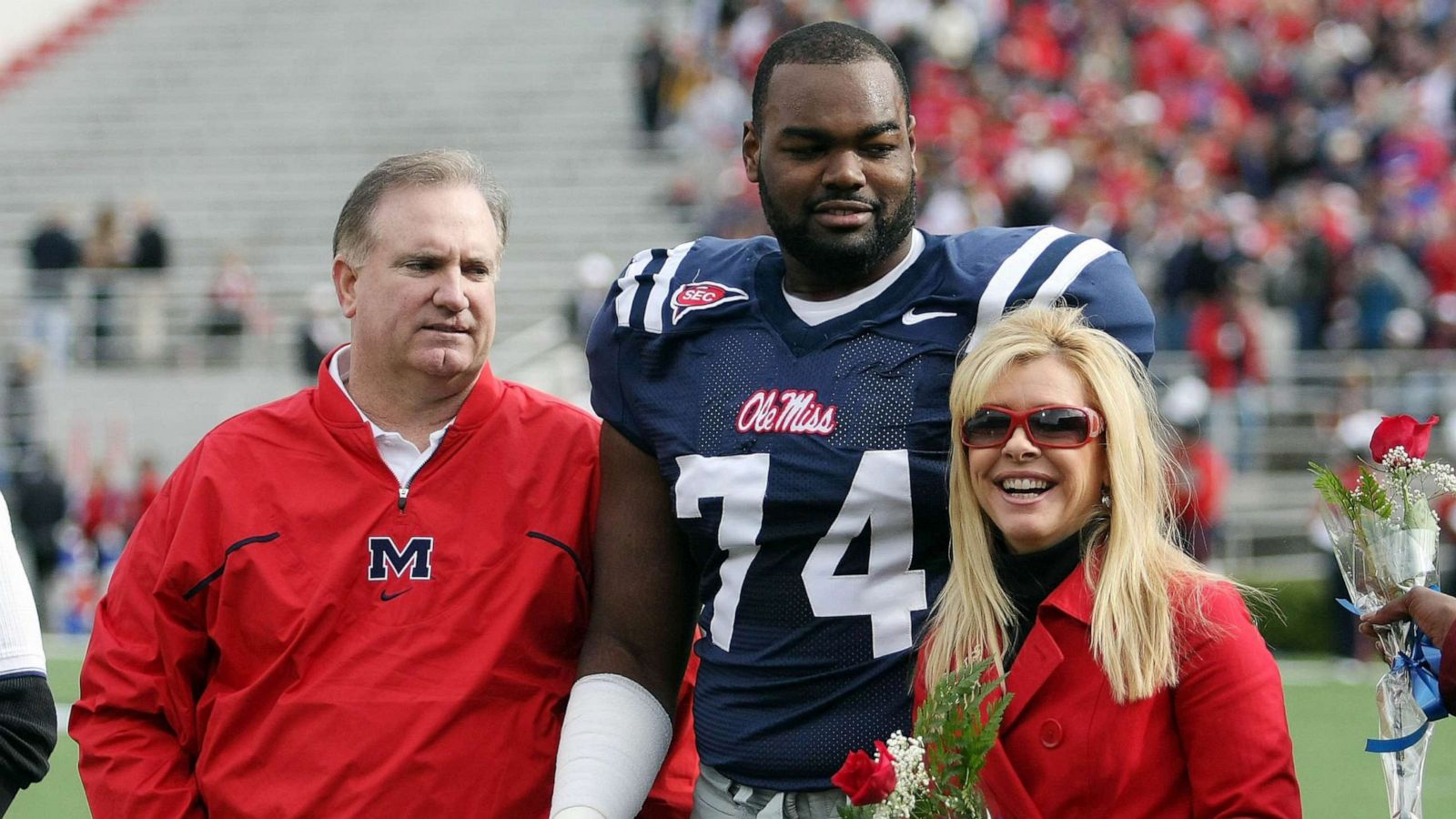 PHOTO: Michael Oher #74 of the Ole Miss Rebels stands with his family during senior ceremonies prior to a game against the Mississippi State Bulldogs at Vaught-Hemingway Stadium, Nov. 28, 2008 in Oxford, Miss.