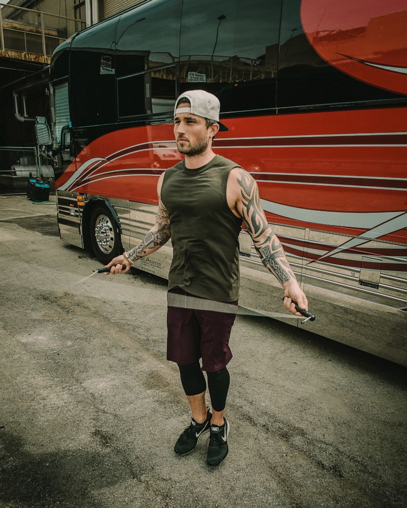 PHOTO: Country music artist Michael Ray working out in front of his tour bus.
