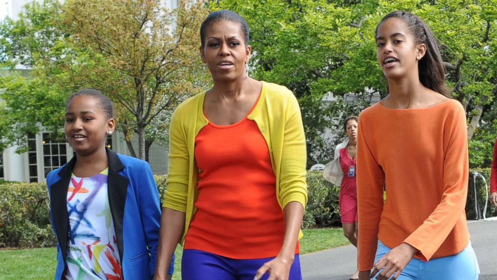 PHOTO: First lady Michelle Obama walks with daughters Sasha and Malia at the annual White House Easter Egg Roll in Washington, April 9, 2012.