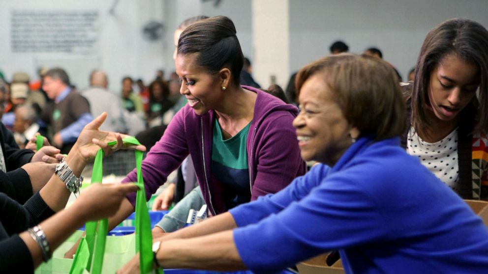 PHOTO: Former first Lady Michelle Obama, Marian Robinson, and Malia Obama help fill bags with produce at the Capital Area Food Bank in North East, Nov. 23, 2011, in Washington, DC.