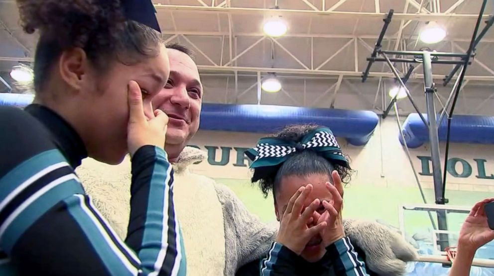 PHOTO: Zoe and A'nina Pasco were cheering at their school basketball game when the mascot was revealed to be their dad.