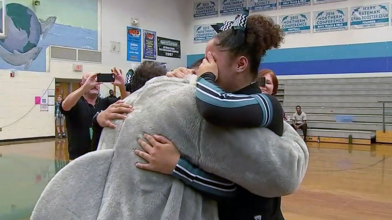 PHOTO: Zoe and A'nina Pasco were cheering at their school basketball game when the mascot was revealed to be their dad, Sgt. Anthony Pasco of the U.S. Air Force.